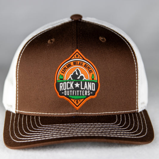 Rock Land Outfitters PVC Logo Patch On A Brown And White Trucker Hat