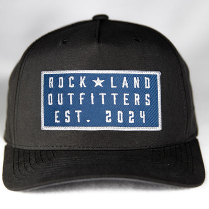 Rock Land Outfitters Blue Logo Patch On A Black Hat